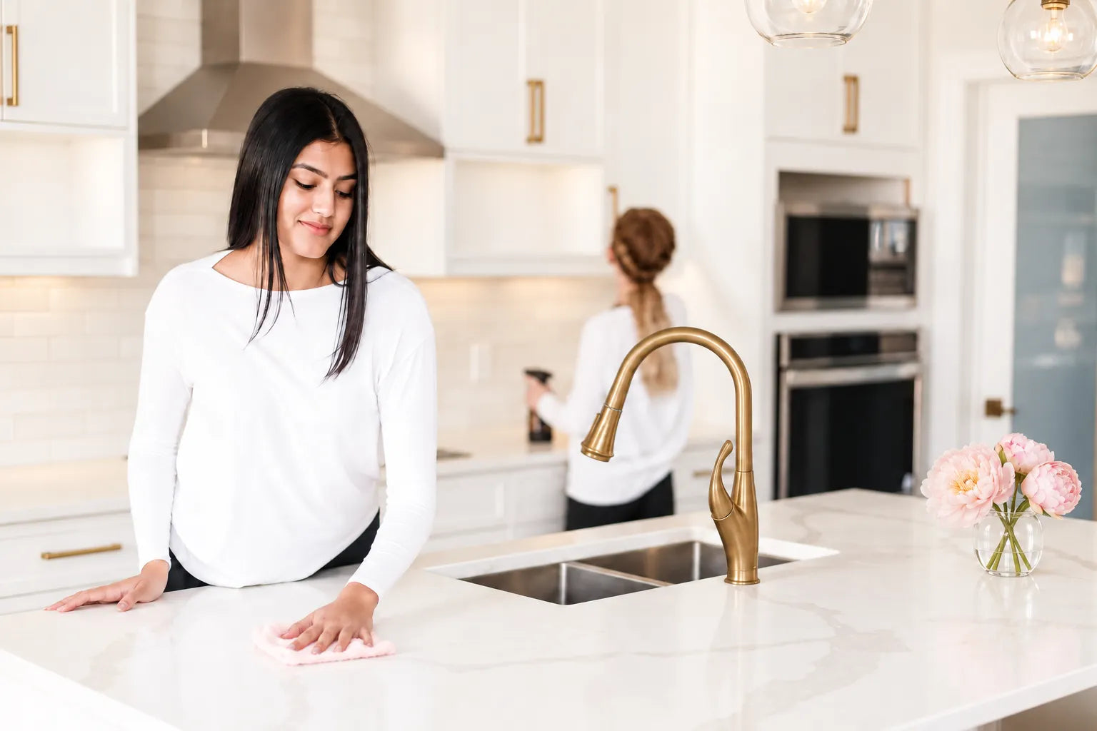 Heritage housekeepers cleaning a bright, elegant kitchen